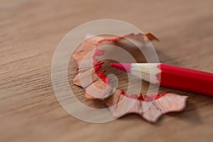 Close-up of red color pencil with pencil shaving