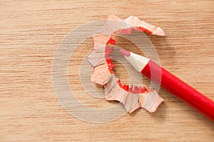 Close-up of red color pencil with pencil shaving