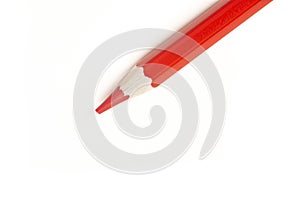 Close up of a red color pencil seen from a high angle on a white background