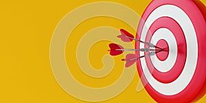 Close up red dart hitting target on yellow background