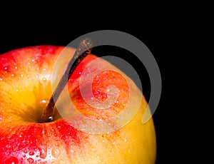 Close-Up Of red delicious apple with water droplets. Isolated on black background