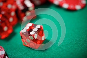 Close-up of a red dices on a green mat