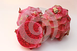 a close up of red dragon fruit isolated on white background.