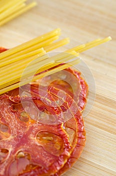 Close-up of Red Dried Tomatoes and Pasta on Wood