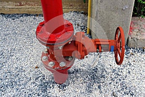 Close up of the red fire hydrant valve on the ground