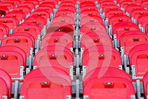 Close up of red folded up seats in football stadium