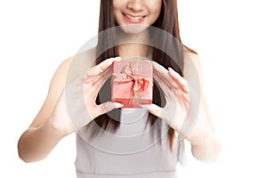 Close up of red gift box in young Asian woman hand