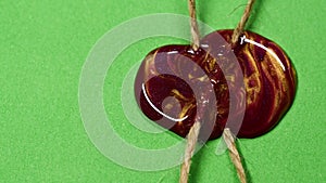 Close-up red and golden wax seal, vintage wax stamp with rope on green paper