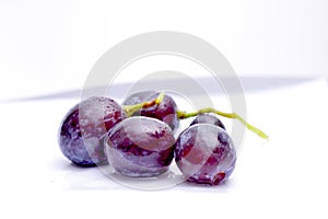 Close-up of red grape on white background