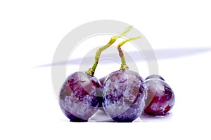 Close-up of red grape on white background