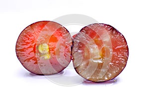 Close-up of red grape on white background