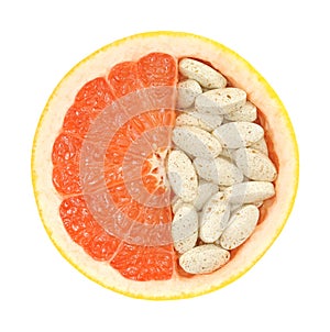 Close up of red grapefruit and pills isolated