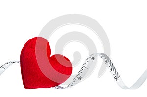 Close up red heart with measuring tape, isolated on white backgr