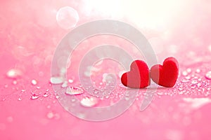 Close up The red Heart shapes with rain water drops on pink sponge surface as love romance abstract background