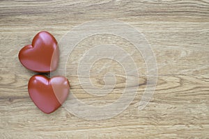 Close-up of Red heart shapes on wooden table background.