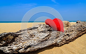 Close up red hearts on ocean beach sand - love concept for holidays