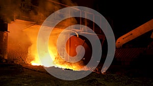 Close up for red, hot molten iron at the steel enterprise, heavy industry concept. Stock footage. Melted steel flowing