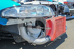 A close-up of a red intercooler on a drift car