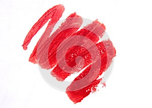 Close-up of a red lipstick smear on a white background