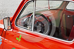 Close-up on a red mini vintage car's wheel