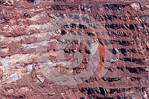 Close-up of red mining levels at iron ore quarry. Open-cast mine, open pit. Background, texture