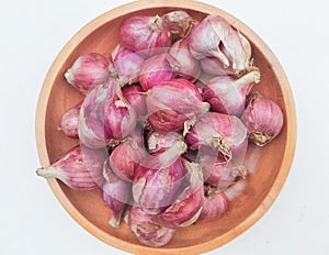 Close-up of red onions in a plate on a white background.