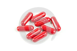 Red pill capsules on white background.