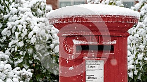 Close up of a Red post box in the snow at Christmas