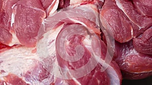 Close-up red raw meat rotates. The meat is fatty pieces with veins. Meat supermarket, raw food theme. Pork red meat cooking. Selec