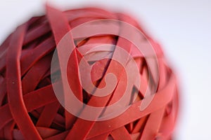 Close up of a red rubber band ball