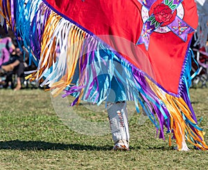 Close Up of Red Shawl with Multi-Colored Ribbons and Rose Applique and Beaded White Knee High Moccasins at a Pow Wow