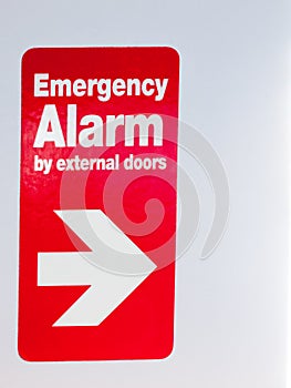 Close up of red sign with direction emergency alarm by external