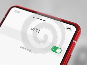 Close-up of a red smartphone with VPN enabled. A modern cell phone with a VPN enabled, on a light background. Using a