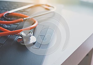 Close up of red stethoscope on desk,Healthcare and medical concept