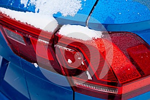 Close-up of red tail lights of a modern car in the winter season