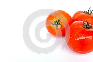 Close up red tomatoes isolated on white background.Tomato with droplets of water.Fresh tomatoes ready to cook.Tomatoes are vegetab