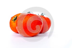 Close up red tomatoes isolated on white background.Tomato with droplets of water.Fresh tomatoes ready to cook.Tomatoes are vegetab