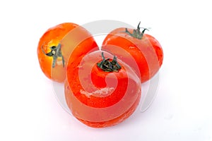 Close up red tomatoes isolated on white background.Tomato with droplets of water.Fresh tomatoes ready to cook.Tomatoes are vegetab