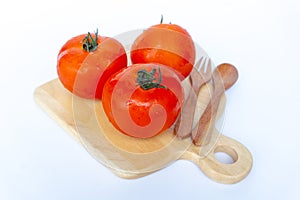 Close up red tomatoes isolated on white background.Tomato with droplets of water.Fresh tomatoes ready to cook.Tomatoes are vegetab