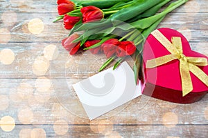 Close up of red tulips, letter and chocolate box