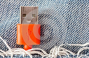 Close-up the red USB cable in jeans pocket