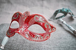 Close up, Selective focus on red venetian masquerade, carnival mask with blurry green mask background