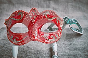 Close up, Selective focus on red venetian masquerade, carnival mask with blurry green mask background