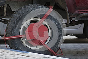 Close up of a red Wheel clamp