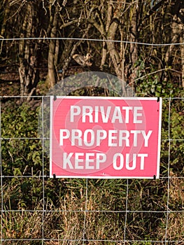Close up of red and white country sign private property keep out