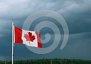 Canadian Flag Waves Ahead of Dark Storm Clouds