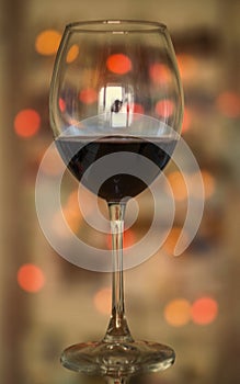 Close up, red wine glass on a bokeh blured background