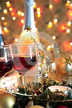 Close-up of red wine in glasses,candle and baubles