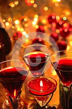 Close-up of red wine in glasses,candle and baubles