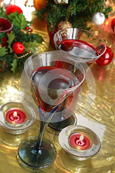 Close-up of red wine in glasses,candle and baubles